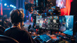 © Maksym - A behind-the-scenes look at an e-sports production crew managing live broadcasts, switching camera angles, and coordinating with on-site staff