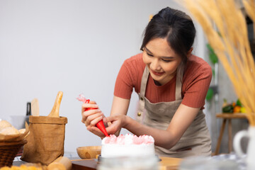 Chef making cake at home. happy relaxing and wellness at home. Young asian woman preparing birthday cake for friends