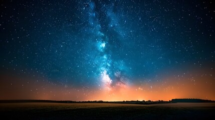 Wall Mural - Starry night sky with the Milky Way, viewed from an open field at dusk. There are no light sources but some distant city lights glowing subtly below. Incredibly beautiful, relaxing.