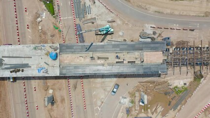 Wall Mural - Aerial view of construction tractor car, bulldozer, or backhoe digging road or street in traffic transportation and agriculture concept. Engine working in urban city town.