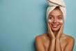 © LukaszDesign - Clean cosmetics, shower, woman and foam face wash in studio on blue background. Happy woman, facial skincare and soap for healthy glow, dermatological or moisturizing beauty