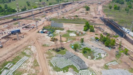 Wall Mural - Aerial view of construction tractor car, bulldozer, or backhoe digging road or street in traffic transportation and agriculture concept. Engine working in urban city town.