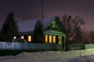 Wall Mural - Wooden house in the village on a cold winter night, after a snowfall