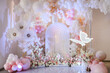 © Serhii - Birthday party for 1 year old girl on a background photo wall. Arch decoration pink, white balloons, text Happy Birthday, flowers, paper decor butterfly. Children's photo zone.