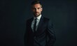 © TheoTheWizard - Elegant portrait of a businessman in a tailored black suit against a dark navy background