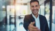 © Thanaphon - Confident businessman in suit offering handshake, representing a professional greeting or business opportunity, in modern office setting.