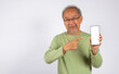 © sorapop - Portrait Asian smiling old man holding a cell phone and pointing to blank screen studio shot isolated on white background, happy senior man showing mobile phone display