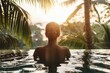 © Konstiantyn Zapylaie - A woman relaxes in a tranquil pool of water, surrounded by towering palm trees in a peaceful oasis setting