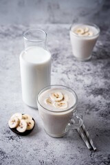 Wall Mural - Banana milkshake with banana slices in a glass