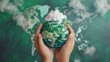 © Togrul - Hand holding green globe with map and have CO2 white cloud on top. Reduce CO2 emissions to limit climate change and global warming. Clean and friendly environment. World sustainable environment.