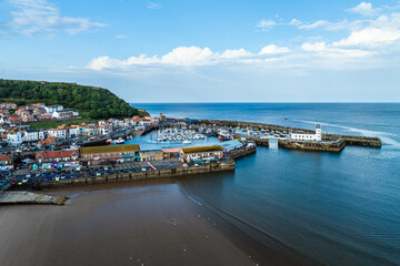 Wall Mural - Scarborough Lighthouse and Harbour from a drone, Vincent Pier, Scarborough, North Yorkshire, England, Europe