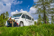 © Tomasz Zajda - Man Reading a Book and Relaxing by Camper Van While on Vacation
