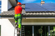© Tomasz Zajda - Professional Worker Installing Solar Panels on Roof