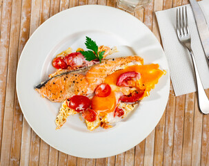 Sticker - Dish of tasty scrambled eggs with salmon and tomatoes at plate on table