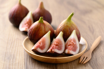 Wall Mural - Piece of fig on wooden plate ready to eating, Healthy fruit