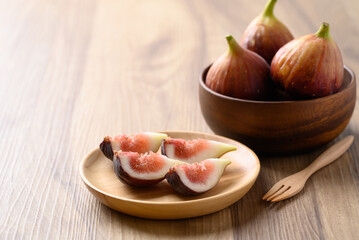 Wall Mural - Piece of fig on wooden plate ready to eating, Healthy fruit