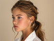 © Daisy - jewelry lookbook, side profile caucasian model with long ponytail, her shoulders are relaxed, her ears are adorned with eye-catching earrings, cream background.