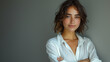 © feeling lucky - A confident business woman wearing a white shirt, standing against a white background with arms crossed