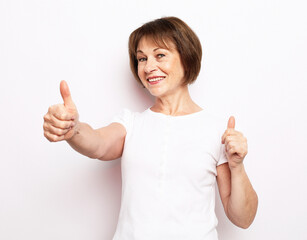 good mood happy smiling positive old woman show ok-sign isolated over white background