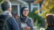 © Kafka - Professional Hijabi Realtor Talking with Client Outside Residential Houses