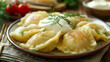 © Oleksandr Blishch - Homemade polish pierogis with sour cream and parsley