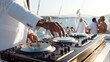 © daniil - DJ mixing music on console mixer board at a luxury yacht party or at a beach party at sea, close-up of dj hands