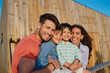 © Westend61 - Happy family in front of beach house on sunny day
