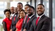 © MD Media - A group of African American business professionals standing in front, smiling and looking at the camera Multiethnic business people working together in the office