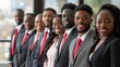 © MD Media - A group of African American business professionals standing in front, smiling and looking at the camera Multiethnic business people working together in the office