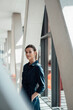 © Westend61 - Businesswoman wearing black dress standing at airport lobby