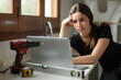 © Antonioguillem - Frustrated woman checking laptop in a house under reform