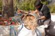 © Antonioguillem - Construction worker emptying carrycot in a debris container