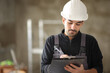 © Antonioguillem - Construction worker taking notes on clipboard