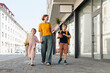 © Westend61 - Happy woman walking with children near building on street