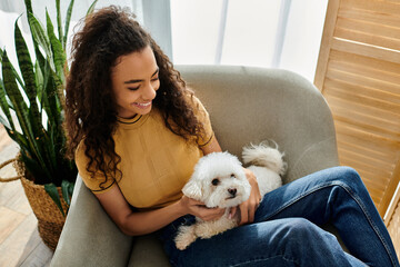 Wall Mural - Woman sitting on couch, holding white dog.