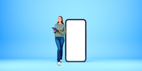 Smiling woman with tablet in hands, mock up blank smartphone display