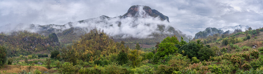 Wall Mural - Rural panoramic landscape of picturesque agricultural mountain valley with low clouds in Chiang Dao countryside, Chiang Mai, Thailand	
