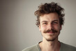 © tinyt.studio - A young guy with moustache and bread and messy hair style smiling to the camera
