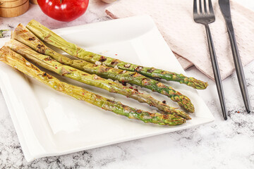 Canvas Print - Grilled asparagus sprouts served red pepper