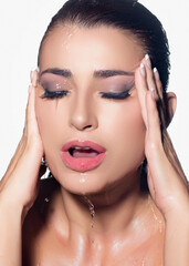 Wall Mural - Close-up of beautiful woman with water on her face showcasing moisturized skin and waterproof makeup