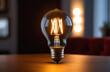 © KatrinA - Incandescent light bulb with tungsten filaments on old rustic grey concrete wall background. Save the energy concept
