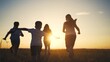 © maxximmm - Silhouette of a group of children running. Concept friends many concept. Silhouette of a family running in the park. Silhouette of a family and lifestyle children running in the park.