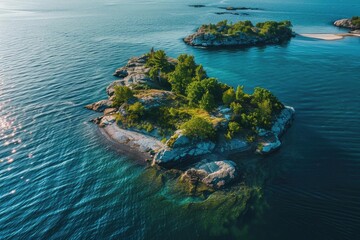 Canvas Print - Aerial view of small, lush island surrounded by clear blue water, with other tiny islands in the background on a sunny day.