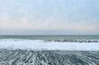 © millaf - Sea background. Sea wave, empty beach and grey sky