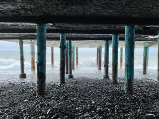 Wall Mural - stormy sea, black stone and grunge pier