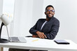 © SHOTPRIME STUDIO - Focused black man in glasses working diligently at desk with laptop and pen, engaged in thoughtful task
