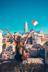 Wall Mural - Female tourist enjoying panoramic view of Matera city landscape in Italy