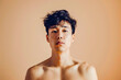 © Tymofii Borysenko - Sad bare-chested Asian man on a beige background