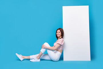 Wall Mural - Full length profile photo of pretty lady sit big telephone empty space present program comfort trip isolated blue color background