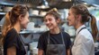 © ifoto - Three young restaurant staff members standing next to each other